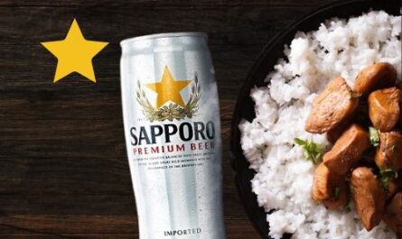 sapporo beer Can on wooden table top with food