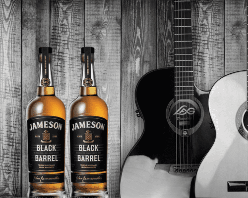 jameson black barrel two bottle with wooden back ground 